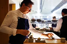 Star chef Heinz Reitbauer plating dishes at the Steirereck restaurant