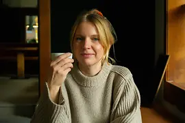 Restaurant owner Lisa Machian holding a cup of coffee