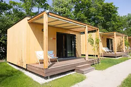 Wooden tiny houses with a patio at the campground