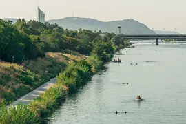 The banks of the Danube Island with swimmers