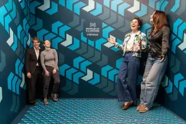 Ames Room with visitors at the Museum of Illusions 
