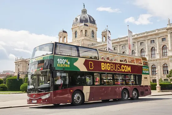 Red electric hop-on hop-off double-decker bus by Big Bus Tours in front of the Natural History Museum Vienna