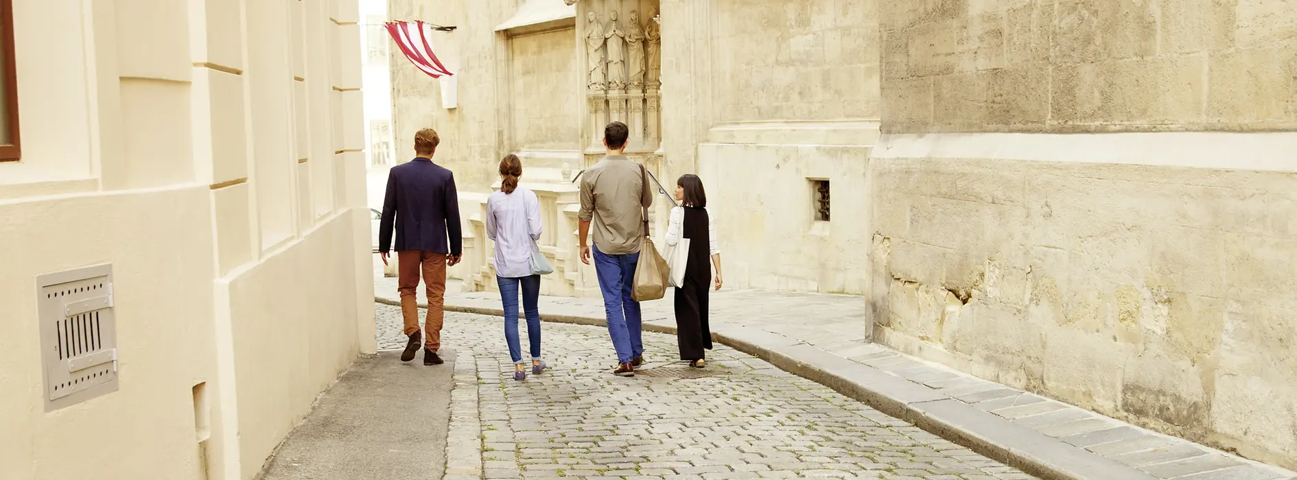 Four people strolling through the old town of Vienna