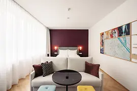 Hotel room with a purple wall at Hotel Schani Salon 