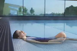 Woman relaxing in the waters of Therme Wien, Vienna's thermal baths