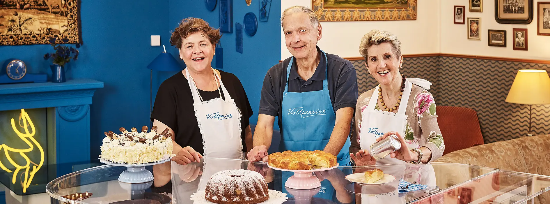 Three elderly ladies behind the coffee house counter 