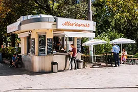 Guests in front of a sausage stand with parasol