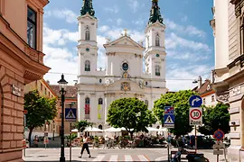 View of the Piarist Church with guest gardens in front of it