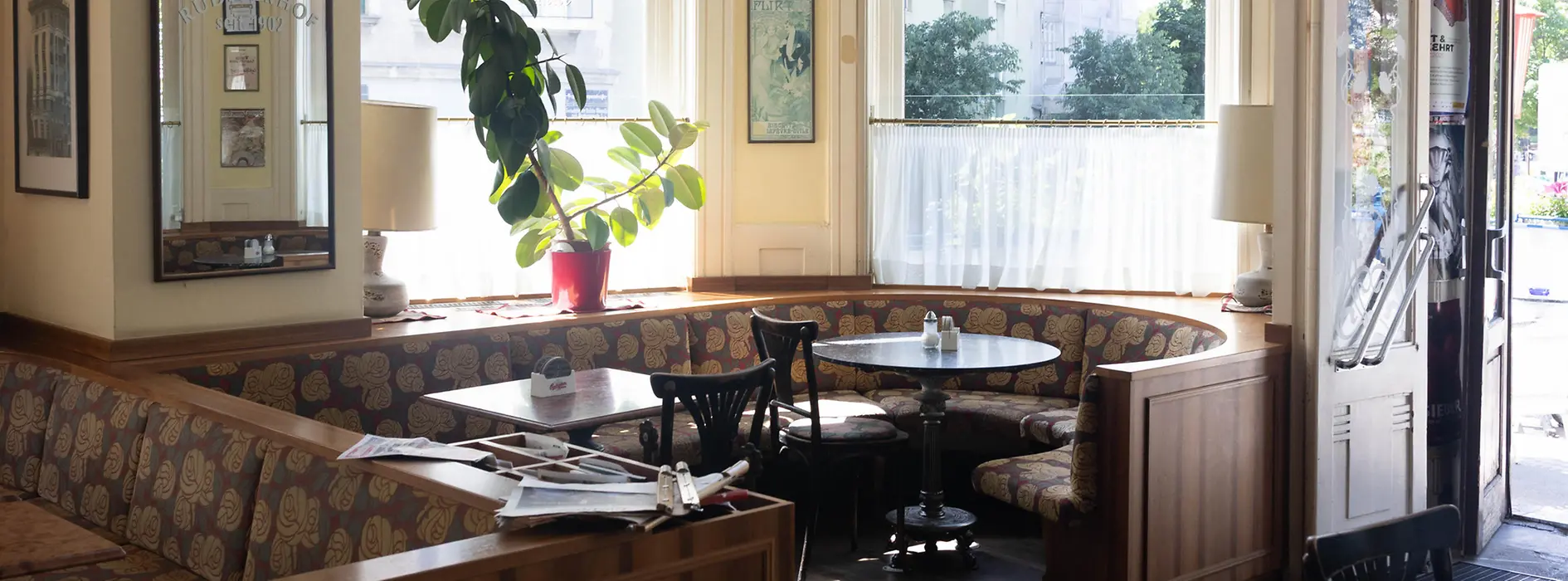 Interior of Café Rüdigerhof in Vienna with booth seating and large windows